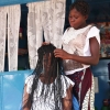 Djumansi er i lære som frisør. Hun klipper og fletter kundernes hår. Foto: Cissé Amadou.